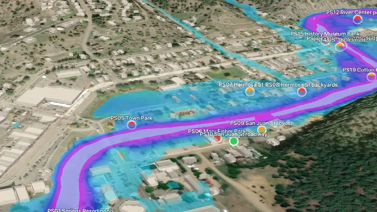Oblique 3D view of the San Juan River through Pagosa Springs with modelled peak flood depth in cyan and magenta and markers at reported flooding